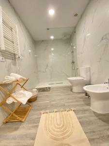 a bathroom with a sink and a toilet and a tub at Casa do Pelourinho in Arcos de Valdevez +26 photos