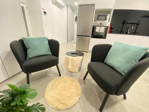 a living room with two chairs and a couch at Casa do Pelourinho in Arcos de Valdevez
