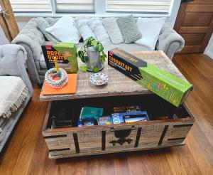 a coffee table in front of a couch with books at Beach House in Surf Beach +28 photos