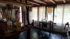 a kitchen with a table and chairs and a refrigerator at Casa ecologica artesanal in Santa Ana +8 photos