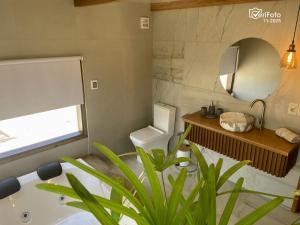 a bathroom with a tub and a toilet and a sink at OHANA in Punta Del Diablo +26 photos