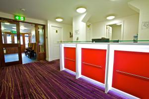 a large room with a stairway leading to a hallway at Ayre Hotel & Ayre Apartments in Kirkwall