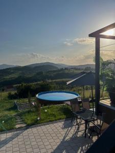 a table and chairs on a patio with a view at Villa Monteverde Goč in Stanišinci