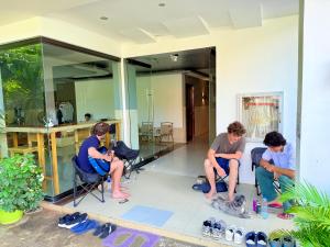 a group of people sitting in chairs on a house at Goofy Ants Hostel in Puerto Princesa City