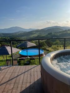 a hot tub with tables and umbrellas on a deck at Villa Monteverde Goč in Stanišinci +97 photos