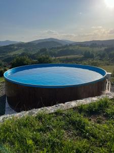 a large pool in the middle of a field at Villa Monteverde Goč in Stanišinci