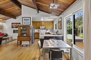 a kitchen and living room with a table and chairs at Moondance in Monte Rio