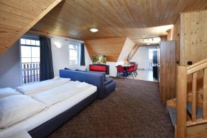a large bedroom with a large bed and a desk at Penzión Valaška in Starý Smokovec +116 photos