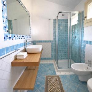 a bathroom with a sink and a toilet and a shower at Pedra Smeralda in Golfo Aranci +42 photos