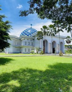 a large white building with a dome on top at Cozy Homes BnB in Prampuan