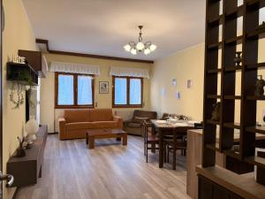 a living room with a couch and a table at AlipierHome Bernina Gateway Comfort e Spazio vicino al Trenino Rosso in Tirano