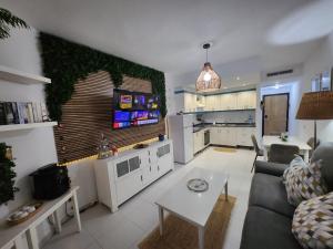 a living room with a couch and a table at Ocean Luxury Apartment in Mogán