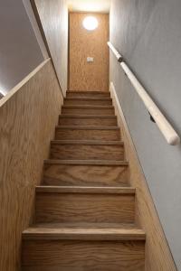 a staircase in a building with wooden steps at Easy Loft Milano in Crescenzago