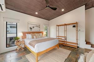 a bedroom with a large bed and a window at The Boho Casa - Beachside Retreat with Pool in Darwin +22 photos