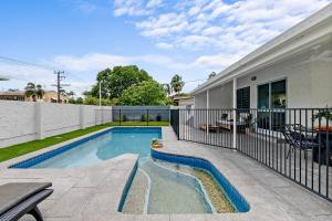 a swimming pool in the backyard of a house at The Boho Casa - Beachside Retreat with Pool in Darwin