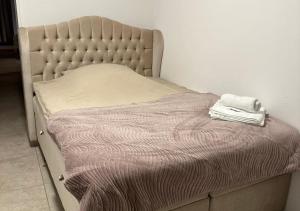 a bed in a bedroom with a mattress and a towel at Rheinpanorama Penthouse Neuss Düsseldorf in Neuss