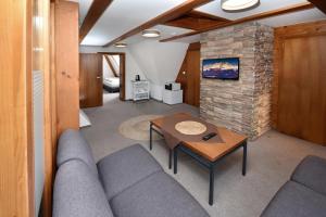 a living room with a couch and a table at Penzión Valaška in Starý Smokovec