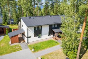an aerial view of a white house with a black roof at Kylpyla Spa Villa Saimaan Harmonia in Imatra