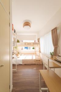 a bedroom with a bunk bed and a desk at Hotel Emile 101 in Tachikawa