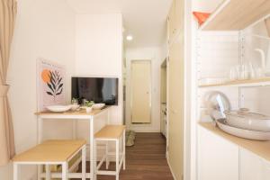 a kitchen with white counters and a sink in a room at Hotel Emile 101 in Tachikawa +51 photos