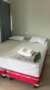 a bed with a blanket on top of it at Hotel Serrinha in Botumirim +4 photos