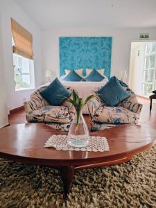 a living room with a couch and a vase on a table at Hotel Los Palomos in Lunahuaná +107 photos