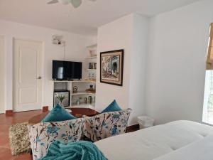 a living room with a couch and a table at Hotel Los Palomos in Lunahuaná