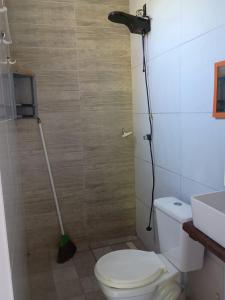 a bathroom with a toilet and a vacuum at Villa Tropical Herbert in Itacaré