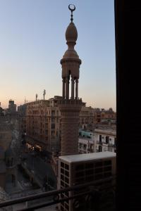 a tower with a cross on top of a city at Meramees Hotel in Cairo