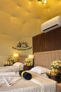 a hotel room with two beds and a sign on the wall at Rum Horizon Bubble luxury camp in Wadi Rum