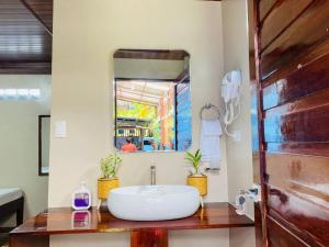 a bathroom with a sink and a mirror at LADY GHAGHA ROOM RENTALs in San Vicente +98 photos