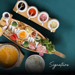 a wooden tray filled with different types of food at Wyndham thanh thủy in La Phu