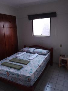 a bedroom with a bed with towels on it at Apartamento com piscina e churrasqueira privativas in Cabedelo