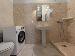 a bathroom with a washing machine and a sink at Apartamento Espargos in Espargos +9 photos
