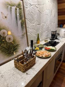 a kitchen counter with two plates of food and wine at Zamaya Bangalôs in Sao Jorge +98 photos