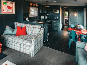 a living room with a couch and a kitchen at The Game Keeper - Uk50611 in Sabden