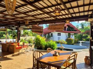 an outdoor patio with a table and chairs at Galera Lodge & Cafe in Puerto Galera
