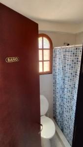 a bathroom with a toilet and a window at Velero de Mar in Las Grutas +40 photos