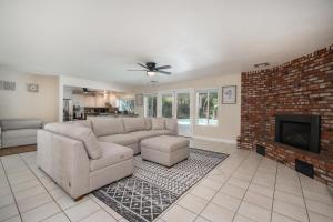 a living room with a couch and a fireplace at Your Poolside Hideaway in Bakersfield