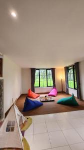 a living room with colorful pillows on the floor at Cypress Resort Cipanas in Barukupa