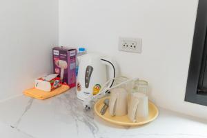 a counter with a coffee maker and glasses on it at IBIZA BEACH Resort in Haad Yao