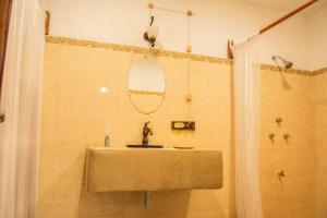 a bathroom with a sink and a shower with a mirror at Casa X'Lapac in Valladolid +5 photos