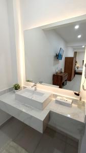 a bathroom with a white sink and a mirror at Punta Colibrí in Brisas de Zicatela