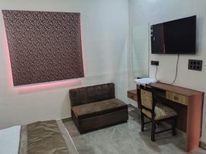 a room with a desk and a chair and a computer at Lords Hotel in Agra