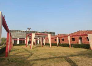 a red brick building with a glass roof at Lords Hotel in Agra