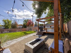 a wooden pergola and a bench in a yard at The Nest with Firepit & Backyard Oasis in Klamath Falls