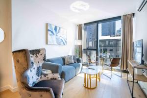 a living room with a couch and a table at Boutique 1B2B HighRise Condo in CBD in Melbourne