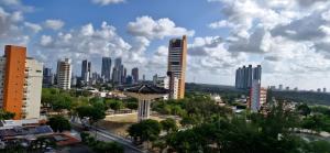 a city skyline with tall buildings and trees at Reserva Madero Loft in Natal