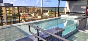 a swimming pool on the roof of a building at Reserva Madero Loft in Natal