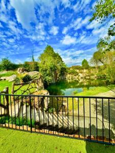 a view of a pond from a fence at Carrière de la Tour in Condé-sur-Sarthe